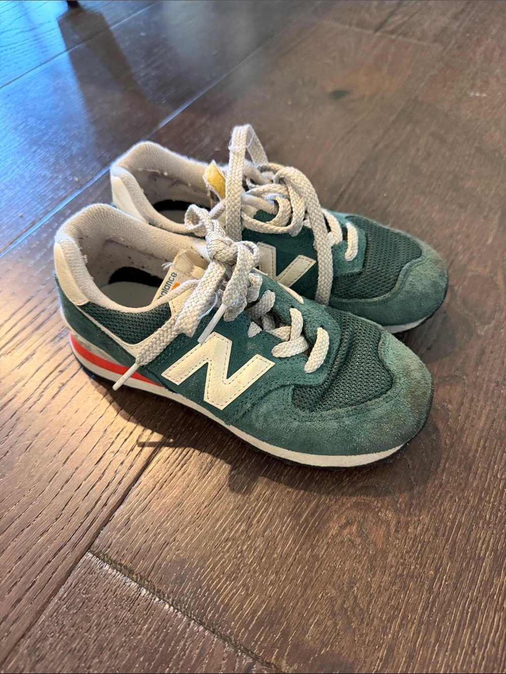New Balance Green and White Kids Sneaker with Red Heel Accent